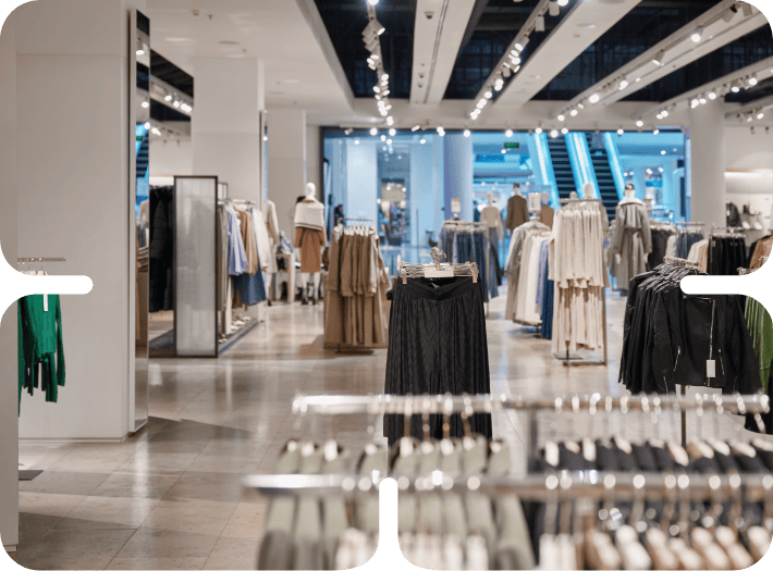 Modern clothing store interior with stylish apparel displays and mannequins in a well-lit retail environment